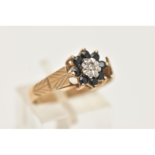 9 - A 9CT GOLD DIAMOND AND SAPPHIRE CLUSTER RING, set with a central single cut diamond illusion set wit... 