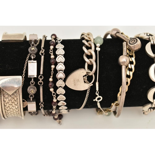 106 - A BLACK SUEDE BRACELET DISPLAY PIECE WITH SILVER AND WHITE METAL BRACELETS, to include a silver flat... 