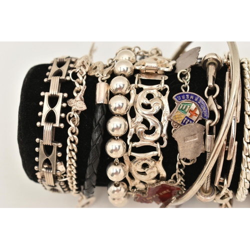 106 - A BLACK SUEDE BRACELET DISPLAY PIECE WITH SILVER AND WHITE METAL BRACELETS, to include a silver flat... 