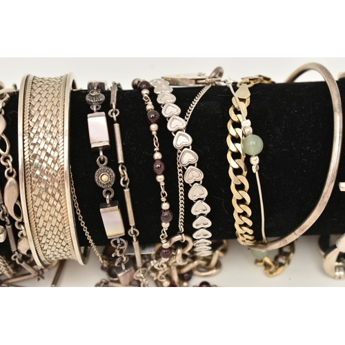 106 - A BLACK SUEDE BRACELET DISPLAY PIECE WITH SILVER AND WHITE METAL BRACELETS, to include a silver flat... 