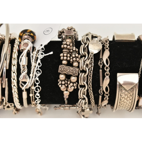 106 - A BLACK SUEDE BRACELET DISPLAY PIECE WITH SILVER AND WHITE METAL BRACELETS, to include a silver flat... 