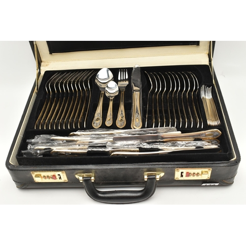 134 - A BRIEFCASE CANTEEN OF CUTLERY, twelve person table setting of two tone stainless steel cutlery, inc... 