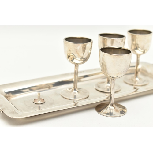 174 - A SET OF FOUR EARLY 20TH CENTURY SILVER LIQUOR GOBLETS WITH TRAY, four small goblets of polished des... 