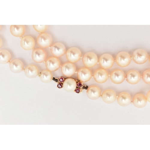 185 - A CULTURED PEARL NECKLACE AND A SINGLE EARRING, the single strand of cultured round white pearls wit... 