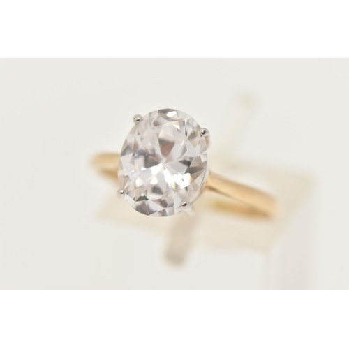 187 - A 9CT GOLD CUBIC ZIRCONIA RING, designed with an oval cut colourless cubic zirconia in a four claw w... 