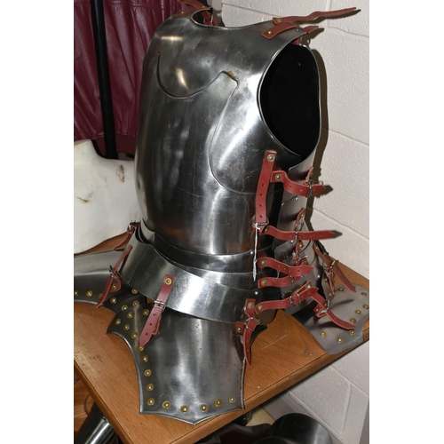 417 - A HALF SET OF ARMOUR AND MANNEQUIN comprising a cuirass and two greaves, with leather buckles, suita... 