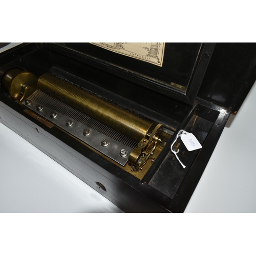 464 - A NINETEENTH CENTURY CYLINDER MUSIC BOX, ebonised case with inlaid decoration of a spray of flowers,... 