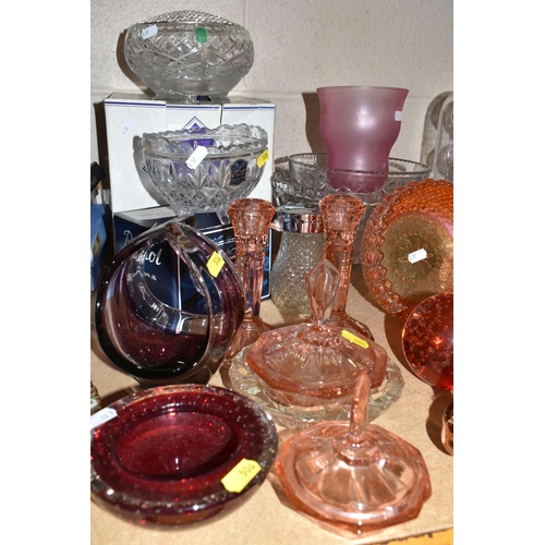 506 - A COLLECTION OF COLOURED GLASSWARE, comprising a collection of glass paperweights, an apple paperwei... 