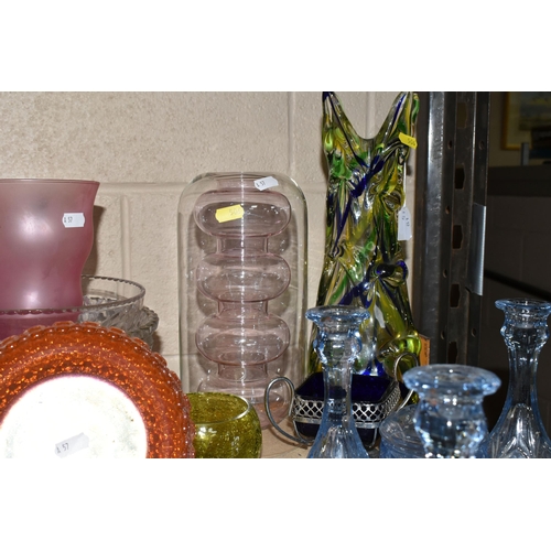 506 - A COLLECTION OF COLOURED GLASSWARE, comprising a collection of glass paperweights, an apple paperwei... 