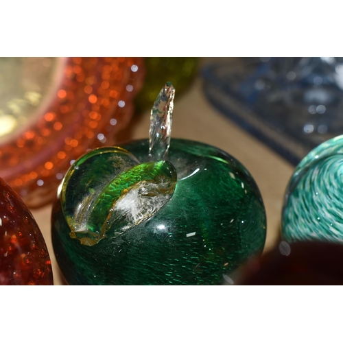 506 - A COLLECTION OF COLOURED GLASSWARE, comprising a collection of glass paperweights, an apple paperwei... 