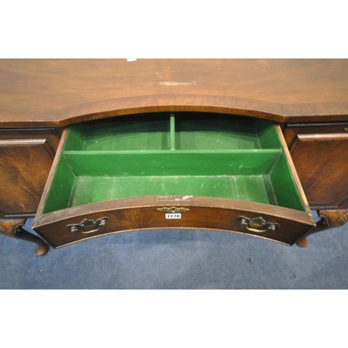 1197 - A 20TH CENTURY QUEEN ANNE STYLE CONCAVE WALNUT SIDEBOARD, fitted two cupboard doors, flanking three ... 