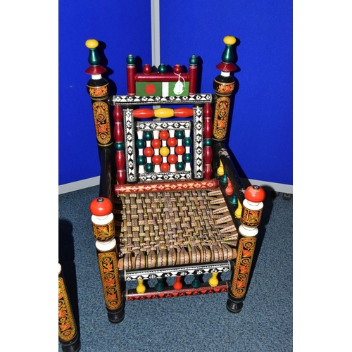 1242 - A PAIR OF 20TH CENTURY PAKISTANI CHARPAI CHAIRS, brightly painted decoration and woven fabric seats,... 