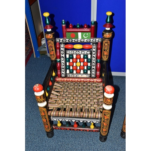 1242 - A PAIR OF 20TH CENTURY PAKISTANI CHARPAI CHAIRS, brightly painted decoration and woven fabric seats,... 