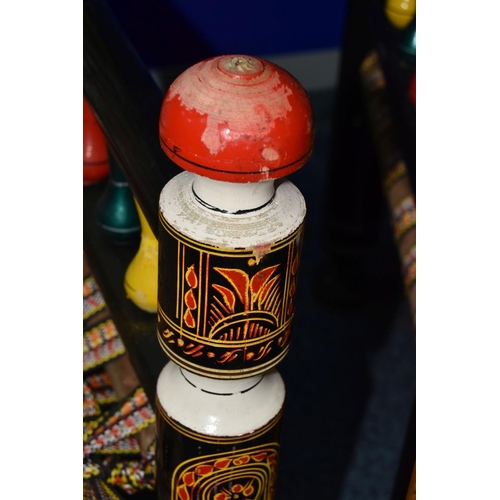 1242 - A PAIR OF 20TH CENTURY PAKISTANI CHARPAI CHAIRS, brightly painted decoration and woven fabric seats,... 