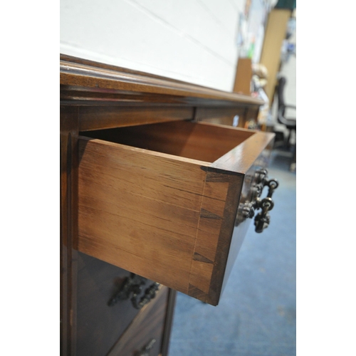 1210 - A 20TH CENTURY OAK AND MAHOGANY KNEEHOLE DESK, with a green leather writing surface, an arrangement ... 