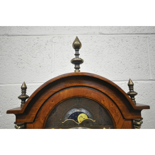 1215 - A LATE 20TH CENTURY WALNUT GRANDMOTHER CLOCK, the arched hood with three brass finials, the glass do... 