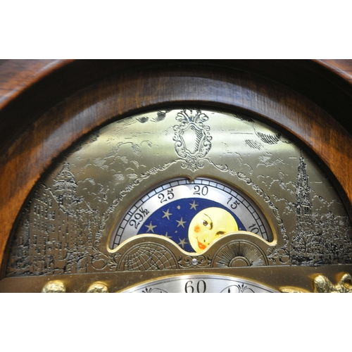 1215 - A LATE 20TH CENTURY WALNUT GRANDMOTHER CLOCK, the arched hood with three brass finials, the glass do... 