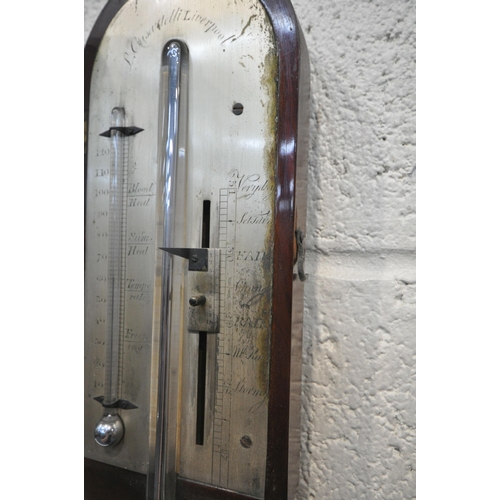 1217 - A GEORGIAN MAHOGANY CISTERN BAROMETER, the arched glass door enclosing a face signed J Casartelli, L... 