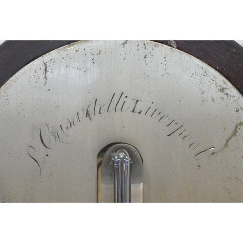 1217 - A GEORGIAN MAHOGANY CISTERN BAROMETER, the arched glass door enclosing a face signed J Casartelli, L... 