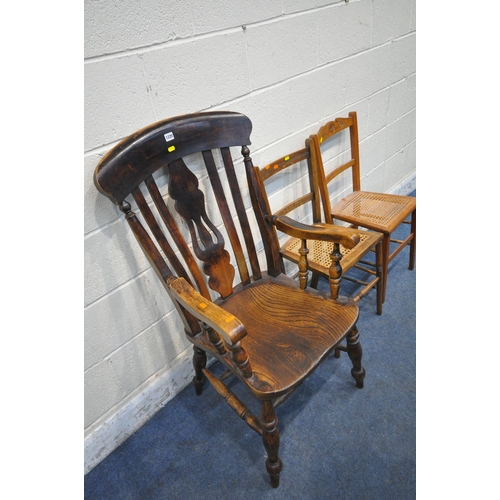 1220 - AN EARLY 20TH CENTURY ELM SEATED ARMCHAIR, with a central splat back, turned supports, scrolled armr... 