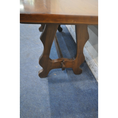 1221 - A 20TH CENTURY OAK RECTANGULAR DINING TABLE, raised on shaped legs, united by a stretcher, length 18... 