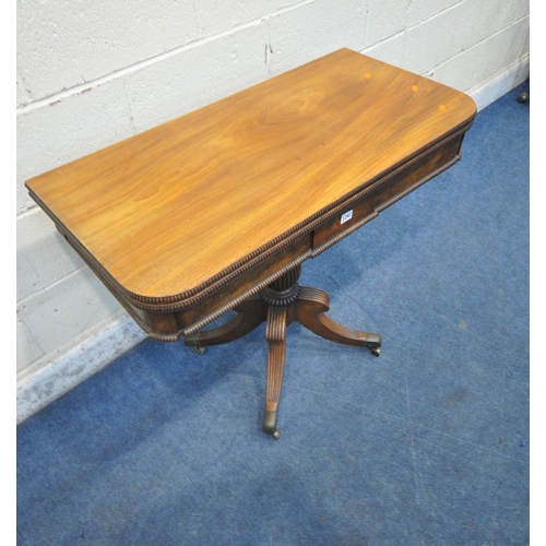 1292 - A REGENCY WALNUT FOLD OVER TEA TABLE, on a shaped fluted support, four splayed legs and brass caps a... 