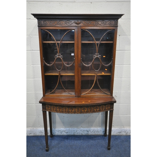 1297 - AN EARLY 20TH CENTURY MAHOGANY BOOKCASE ON STAND, the top with an overhanging cornice, the double as... 