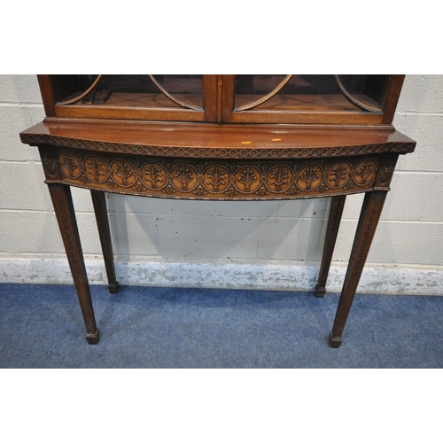 1297 - AN EARLY 20TH CENTURY MAHOGANY BOOKCASE ON STAND, the top with an overhanging cornice, the double as... 