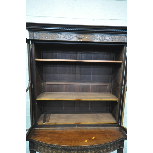 1297 - AN EARLY 20TH CENTURY MAHOGANY BOOKCASE ON STAND, the top with an overhanging cornice, the double as... 