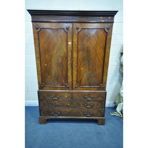 1300 - A GEORGIAN FLAME MAHOGANY CONVERTED LINEN PRESS, the cornice with blind fretwork, double cupboard do... 