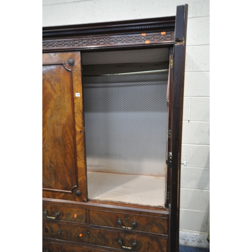 1300 - A GEORGIAN FLAME MAHOGANY CONVERTED LINEN PRESS, the cornice with blind fretwork, double cupboard do... 