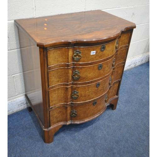 1302 - A REPRODUCTION WALNUT CHEST OF FOUR LONG GRADUATED DRAWERS, with a central shaped front, on bracket ... 