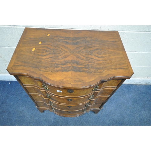 1302 - A REPRODUCTION WALNUT CHEST OF FOUR LONG GRADUATED DRAWERS, with a central shaped front, on bracket ... 