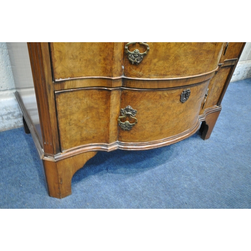 1302 - A REPRODUCTION WALNUT CHEST OF FOUR LONG GRADUATED DRAWERS, with a central shaped front, on bracket ... 