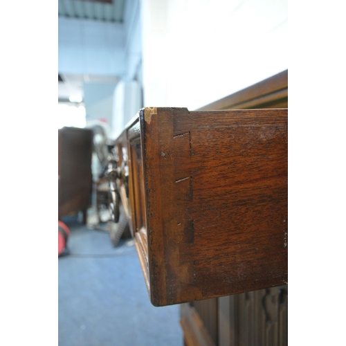 1224 - A LATE 20TH CENTURY OAK SIDEBOARD, fitted with two drawers, above double linenfold cupboard doors, r... 