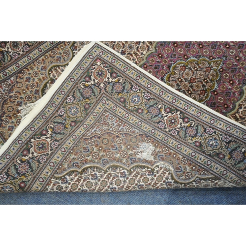 1227 - A RECTANGULAR PERSIAN TABRIZ RUG, with a central medallion, repeating geometric patterns, and a mult... 