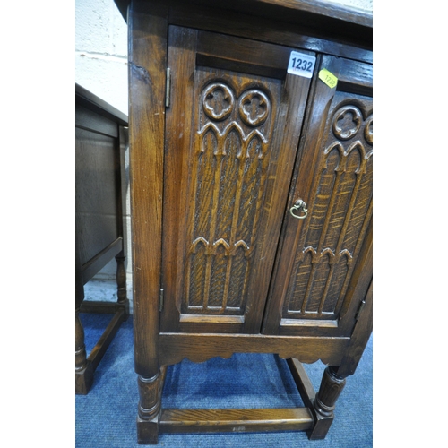 1232 - A 20TH CENTURY OAK DOUBLE DOOR CUPBOARD, raised on turned legs, united by stretchers, width 48cm x d... 