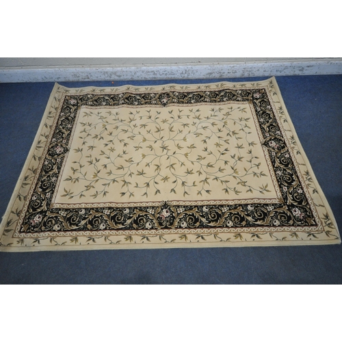 1246 - AN IVORY GROUND RECTANGULAR RUG, with foliate decorations, and a multi-strap border, 230cm x 160cm (... 