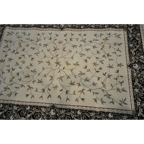 1246 - AN IVORY GROUND RECTANGULAR RUG, with foliate decorations, and a multi-strap border, 230cm x 160cm (... 