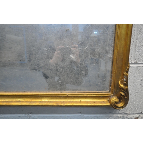 1247 - A 20TH CENTURY GILT FRAMED OVERMANTLE MIRROR, with an arched top and foliate detail, 126cm x 101cm (... 