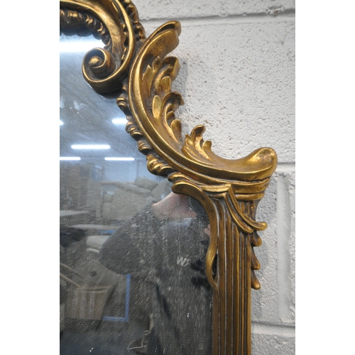 1248 - A 20TH CENTURY GILT FRAMED OVERMANTLE MIRROR, with a shaped foliate top and bottom, and scrolled fol... 