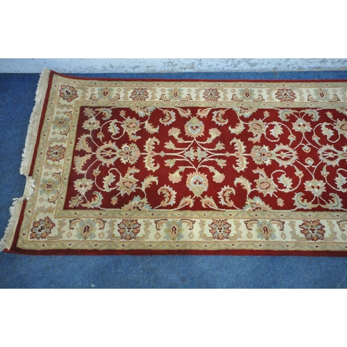 1264 - A SECOND HALF 20TH CENTURY KESHAN RED AND CREAM CARPET RUNNER, 377cm x 97cm (condition report: measu... 