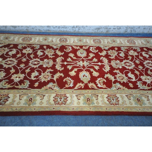 1264 - A SECOND HALF 20TH CENTURY KESHAN RED AND CREAM CARPET RUNNER, 377cm x 97cm (condition report: measu... 