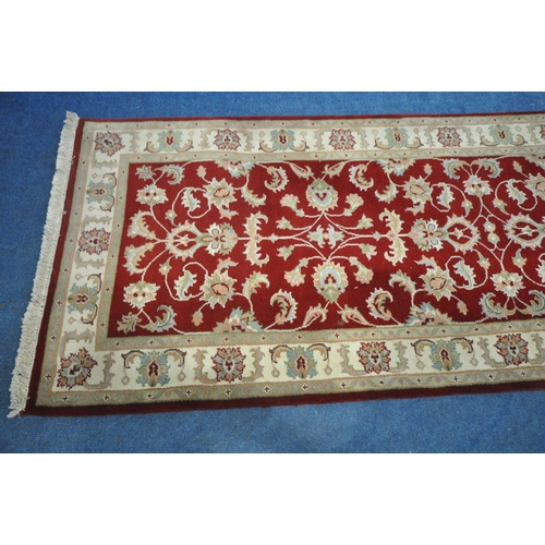 1265 - A SECOND HALF 20TH CENTURY KESHAN RED AND CREAM CARPET RUNNER, 367cm x 96cm (condition report: measu... 