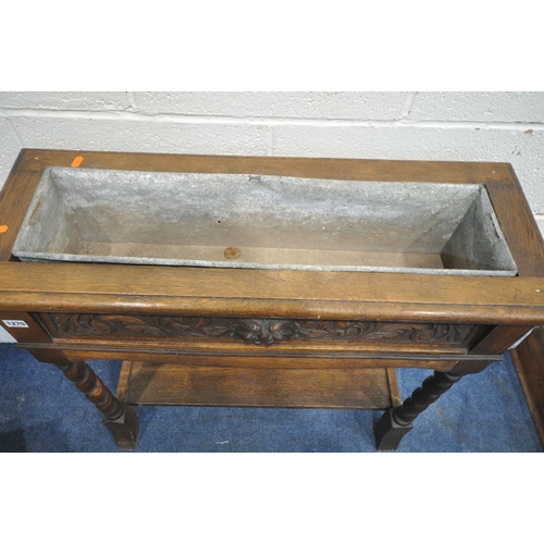 1270 - A 20TH CENTURY CARVED OAK RECTANGULAR PLANTER, with a carved mask panel to the front, galvanised lin... 