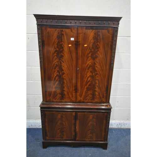 1280 - A MAHOGANY FOUR DOOR DRINKS CABINET, enclosing three glass shelves, cutting slide, atop a base with ... 