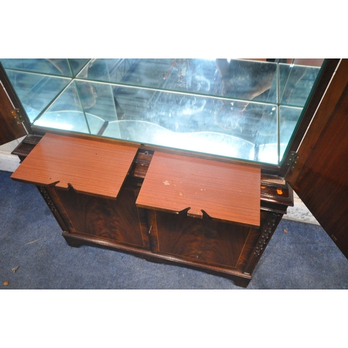 1280 - A MAHOGANY FOUR DOOR DRINKS CABINET, enclosing three glass shelves, cutting slide, atop a base with ... 