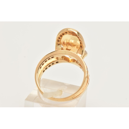 1 - A MODERN YELLOW METAL CITRINE AND DIAMOND DRESS RING, set with an oval shape fancy cut Citrine, meas... 