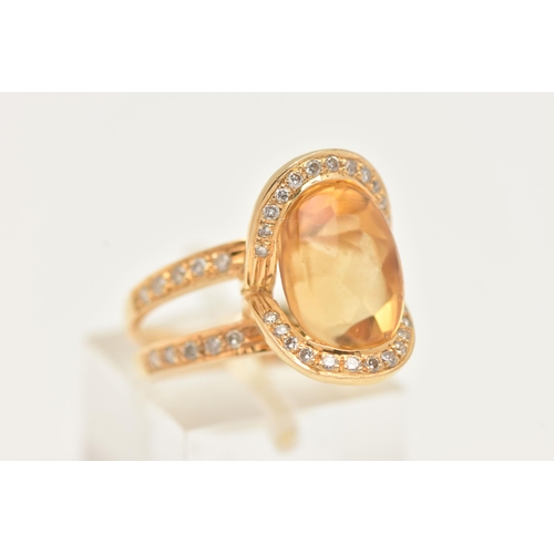 1 - A MODERN YELLOW METAL CITRINE AND DIAMOND DRESS RING, set with an oval shape fancy cut Citrine, meas... 