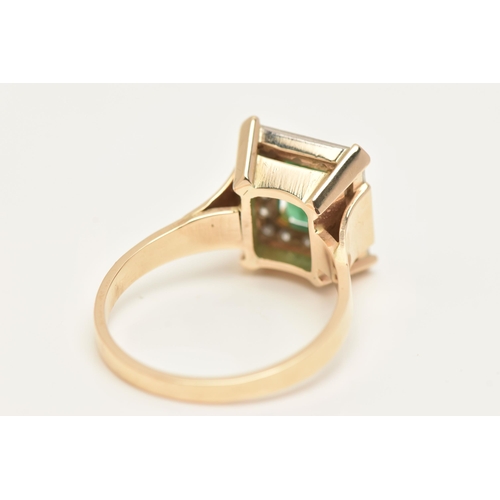 12 - A YELLOW METAL EMERALD AND DIAMOND CLUSTER RING, of a rectangular form, centrally set with an emeral... 